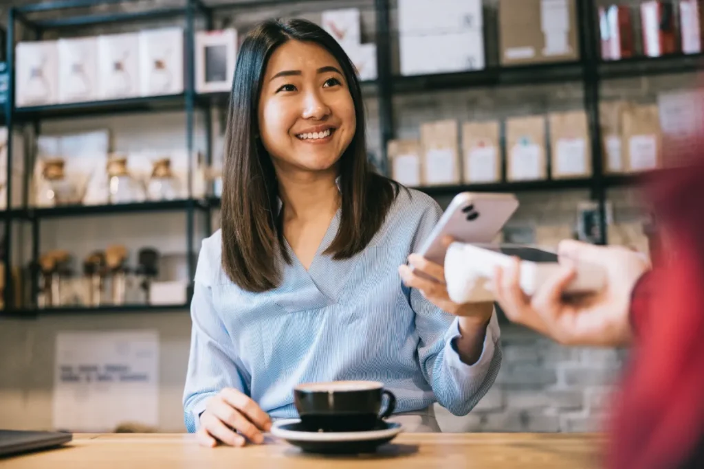 Image of a retailer accepting payment on a phone